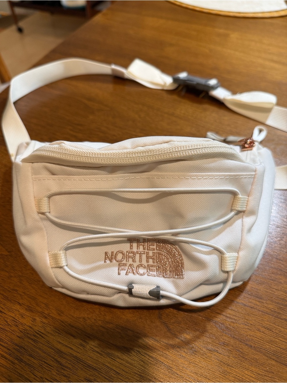 The North Face Cream Crossbody Waist Pack with Rose Gold Logo